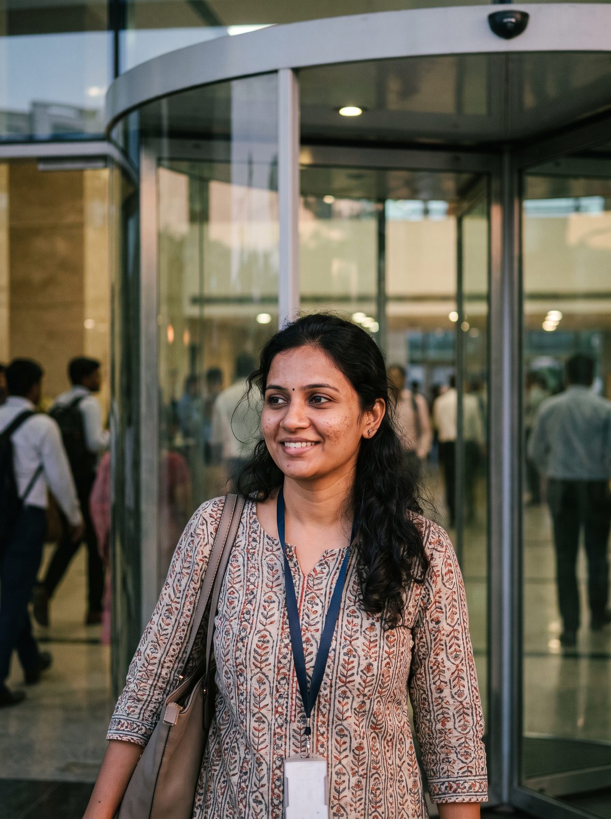A software engineer walking out of her office in Hitec City at the end of the day